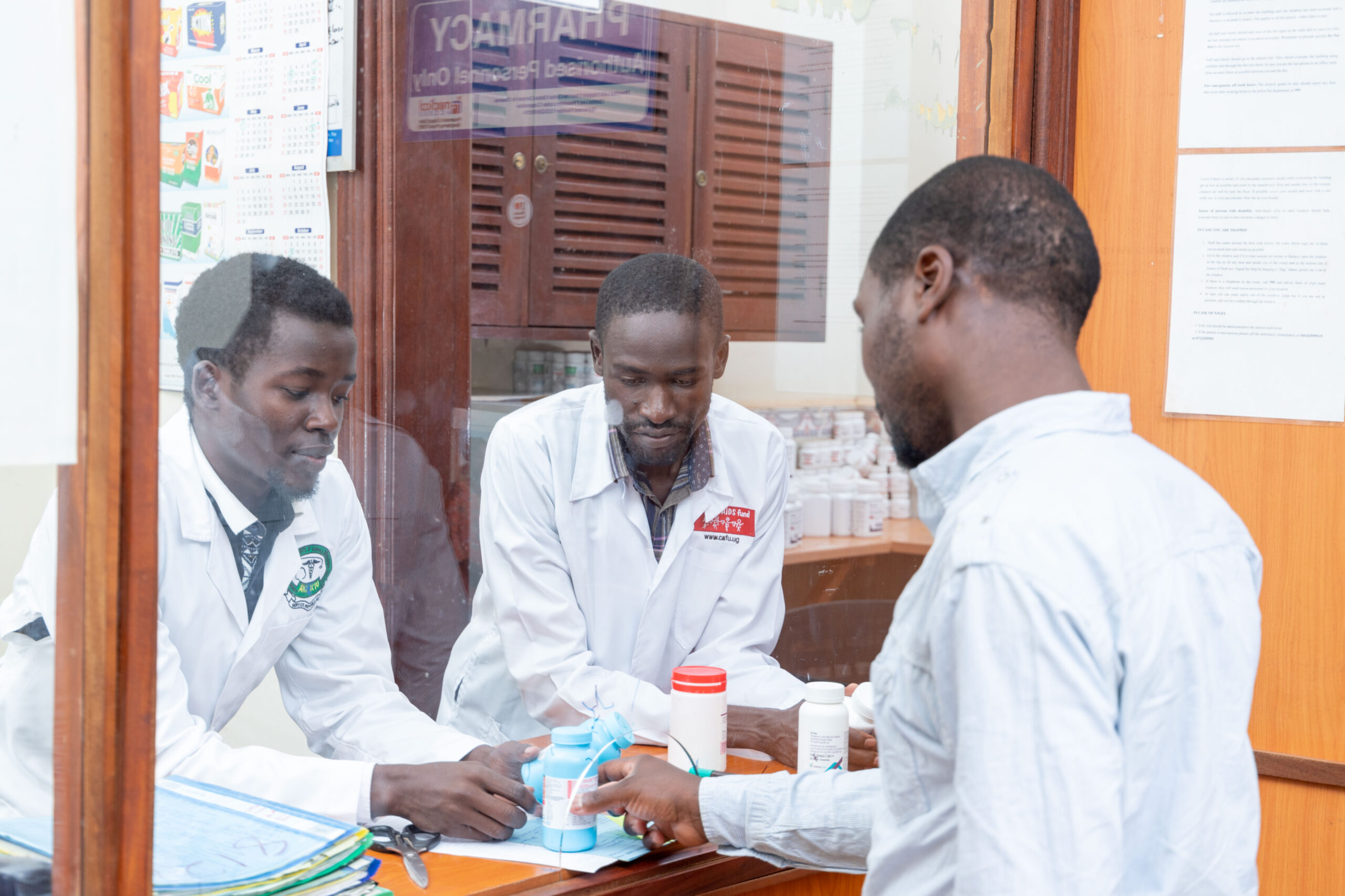 CAFU pharmacy staff assisting a visitor.